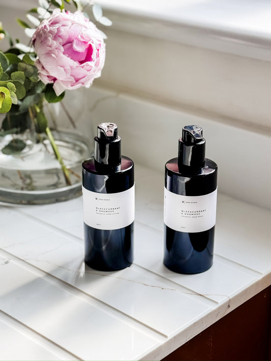 luxury hand wash and Hand Lotion in black bottles on a sink side