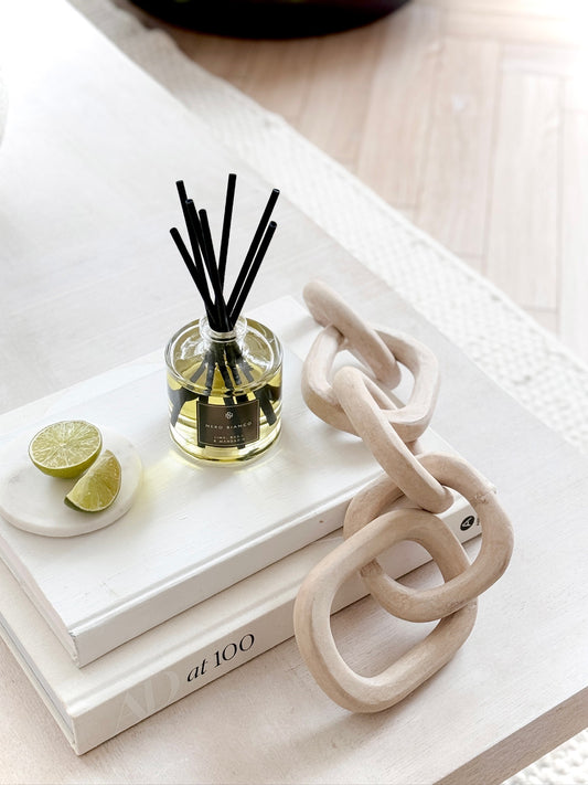 Signature Reed Diffuser Lime, Basil and Mandarin styled on neutral coffee table