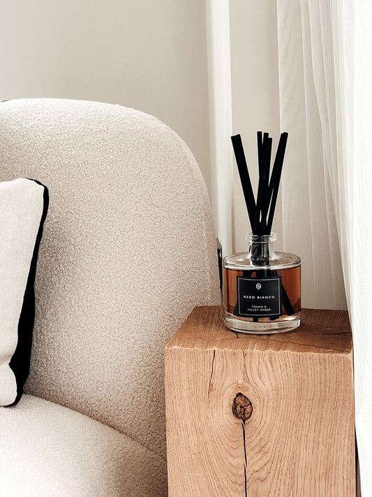 Signature Reed Diffuser: Tonka & Velvet Amber on bedside wooden table