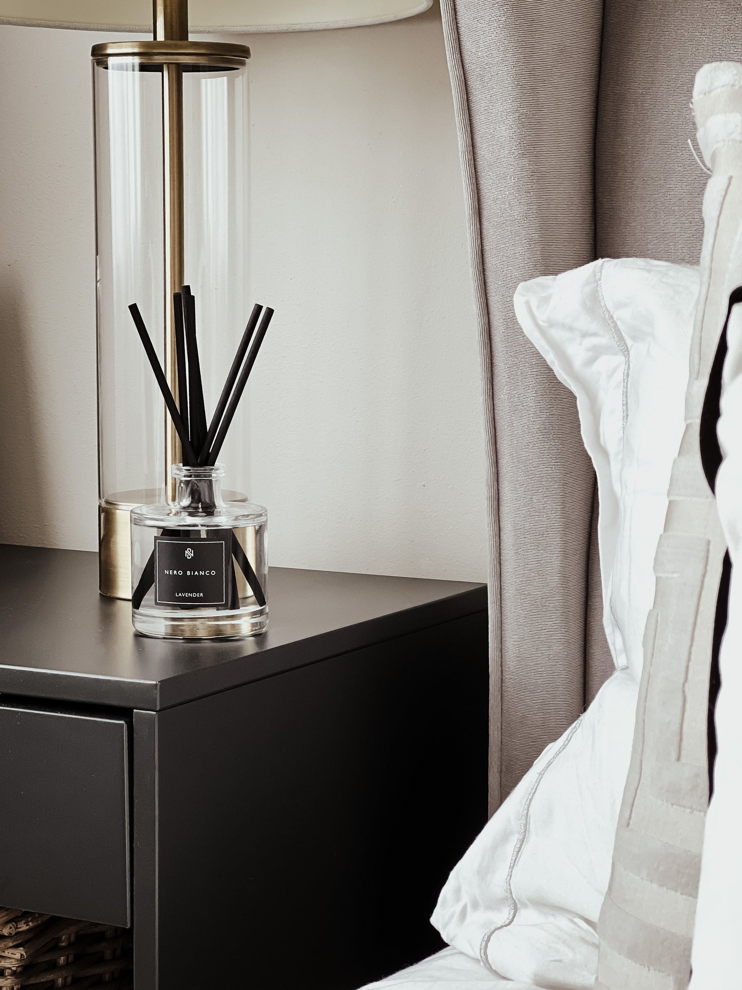 Signature Reed Diffuser lavender styled on dark wood bedside table
