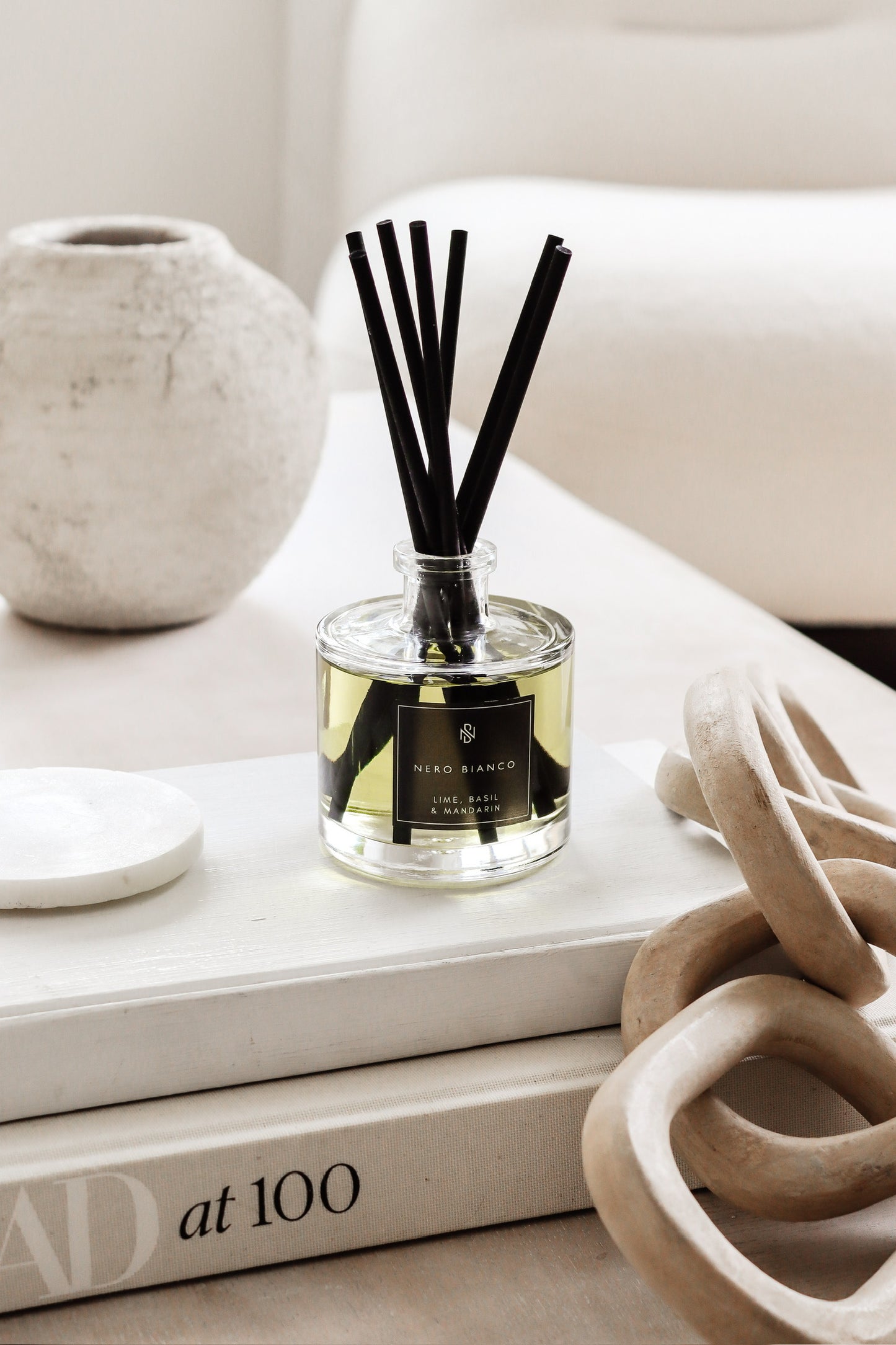 Signature Reed Diffuser lime, basil and mandarin on coffee table with neutral home decor