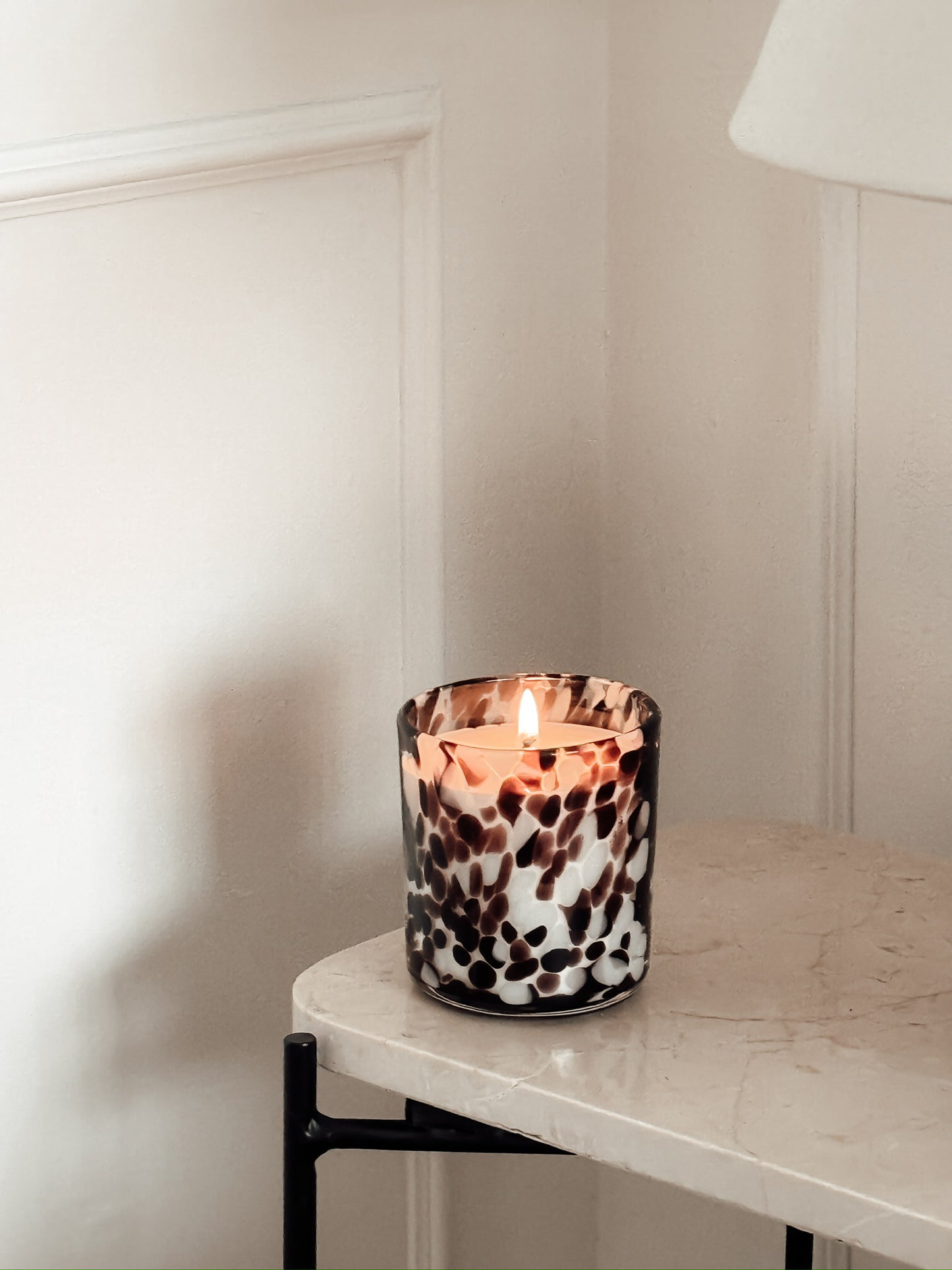 Cheetah Print Candle in burgundy and white on a marble table
