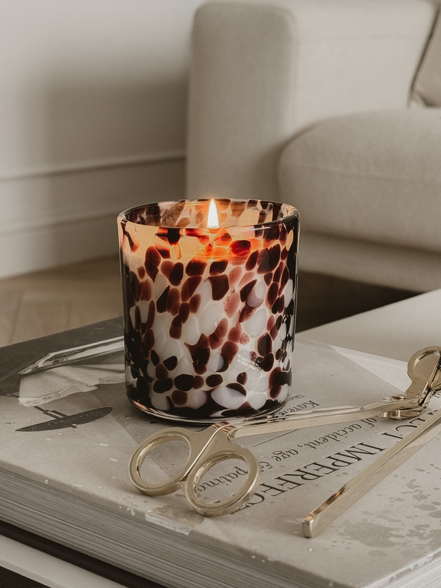 burgundy cheetah print candle close up with gold wick trimmers