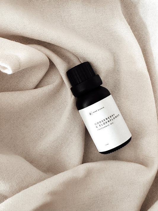 Aroma Diffuser Fragrance Oil gooseberry and elderflower on linen sheet