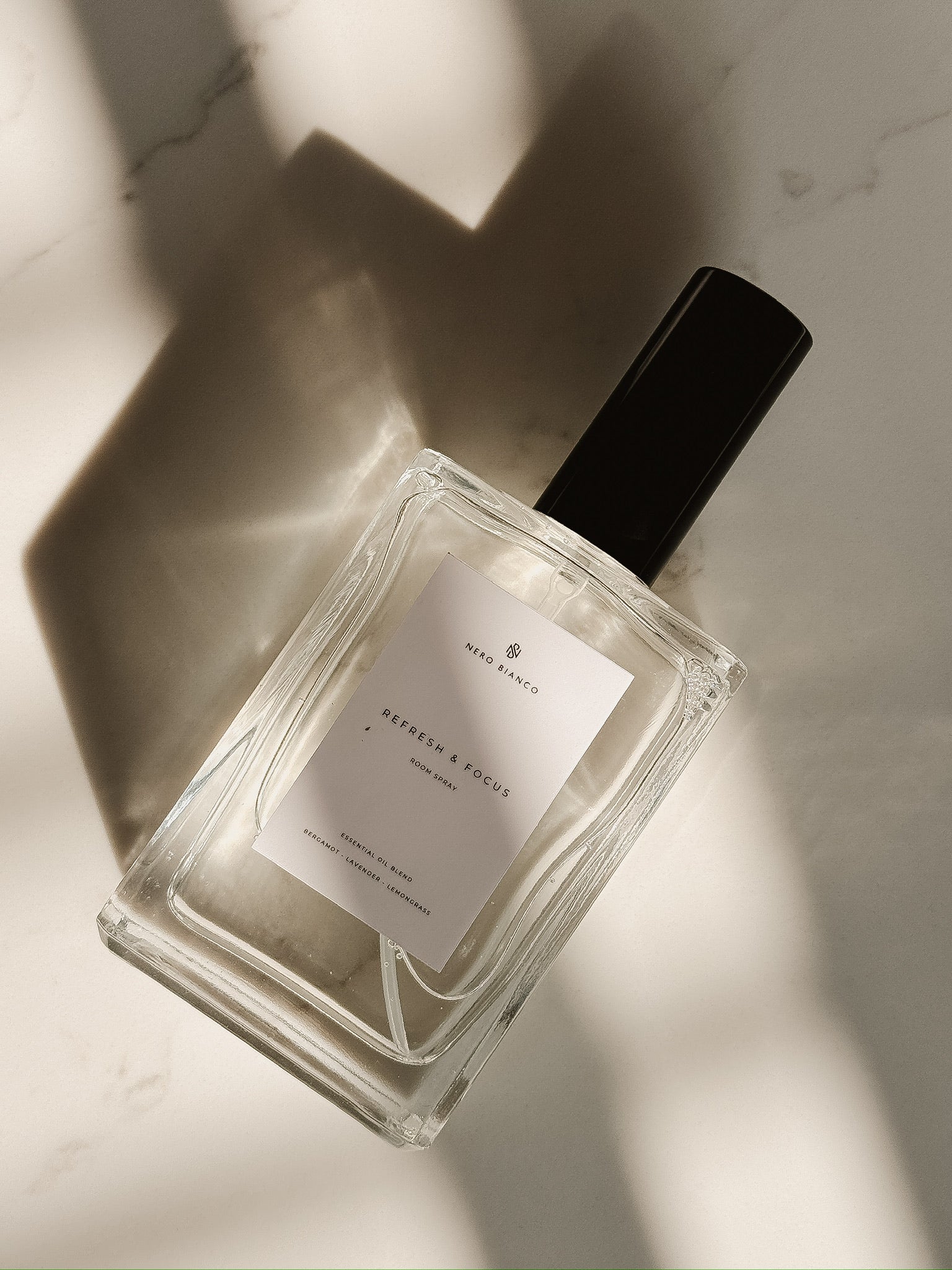 Luxury room spray with essential oils  in glass bottle with a light background