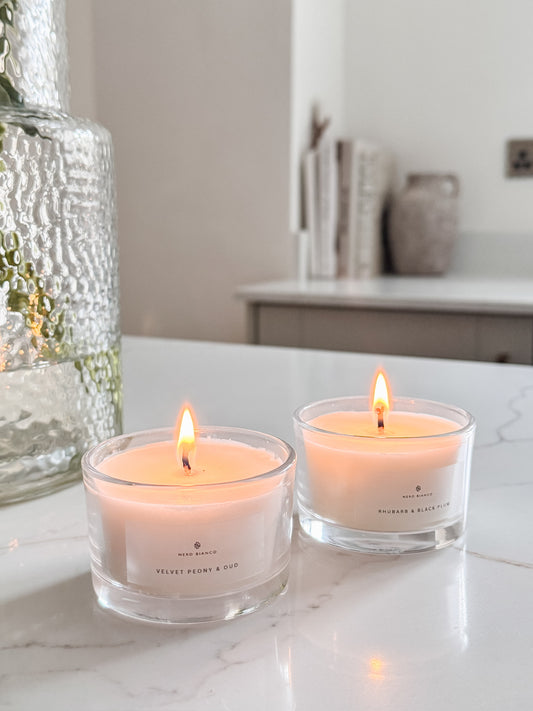 Votive Candles in glass vessel close up shot in a neutral kitchen