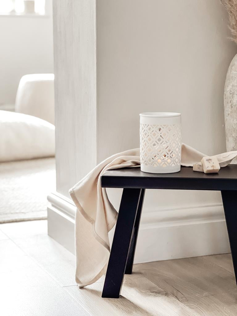 white ceramic wax melt burner in a neutral home decor