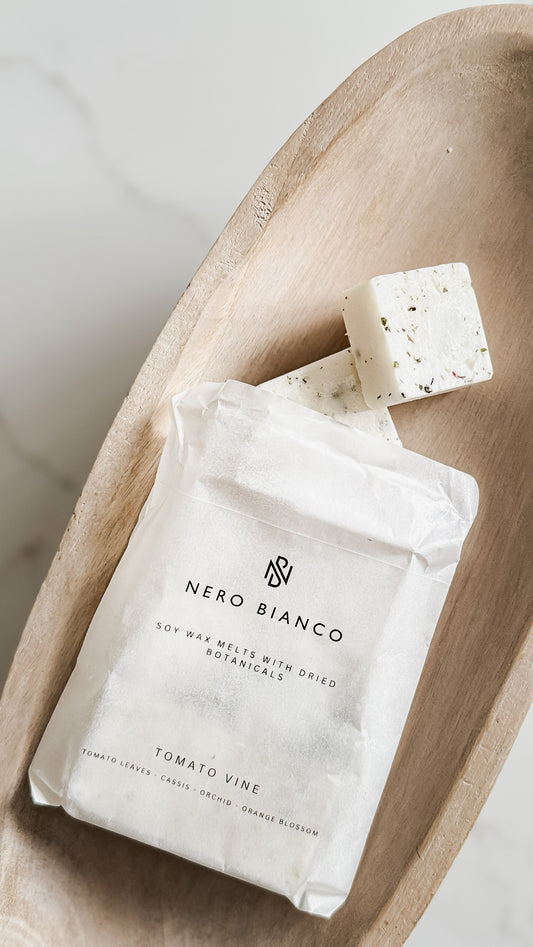 A pack of 6 tomato vine scented wax melts on a wooden board 