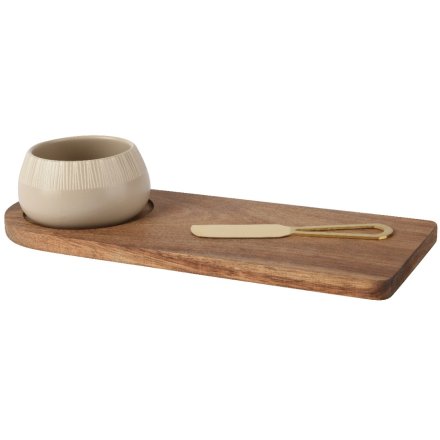 acacia wood cheese board with a ceramic bowl and gold knife on a white background