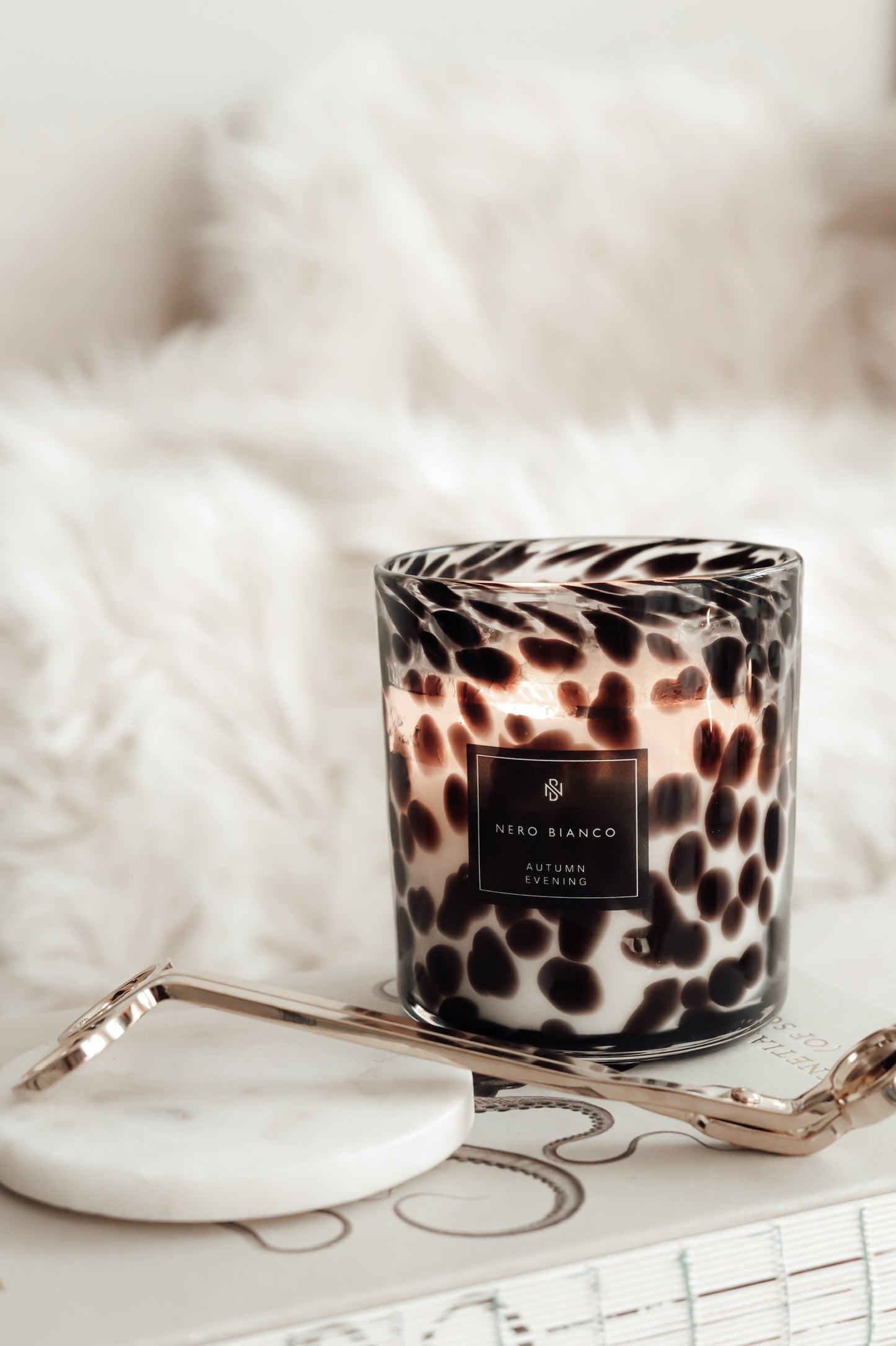 a lit cheetah print candle styles with gold wick snippers