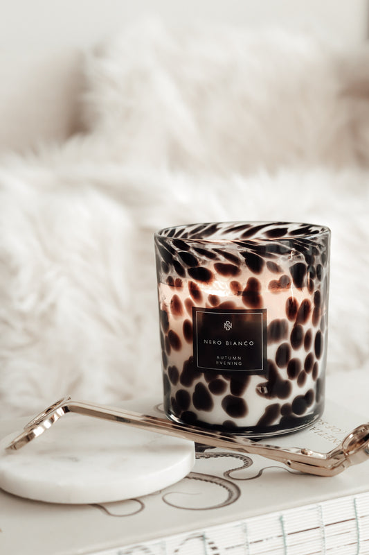 a lit cheetah print candle styles with gold wick snippers