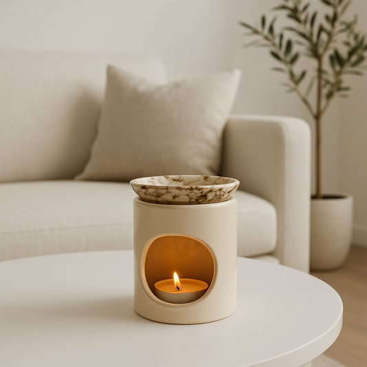 Ceramic wax melt burner with a lit candle on a coffee table in a living room setting.