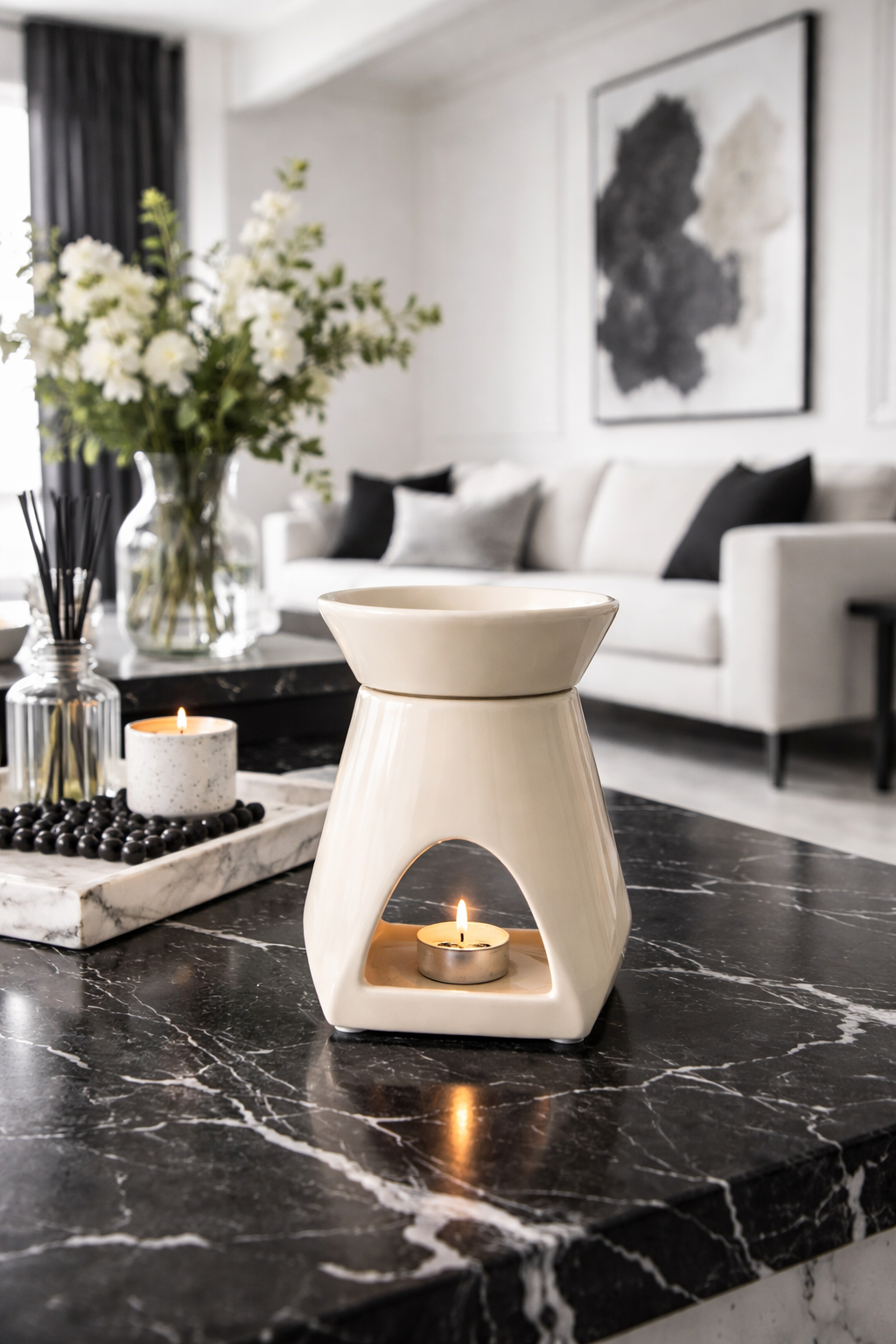 White wax warmer on a black marble surface with a candle inside, in a stylish living room.