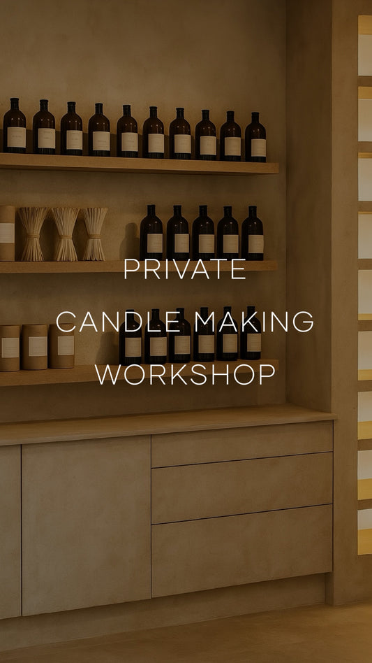 Shelves with bottles and containers labeled 'Private Candle Making Workshop' in a warm-toned room.