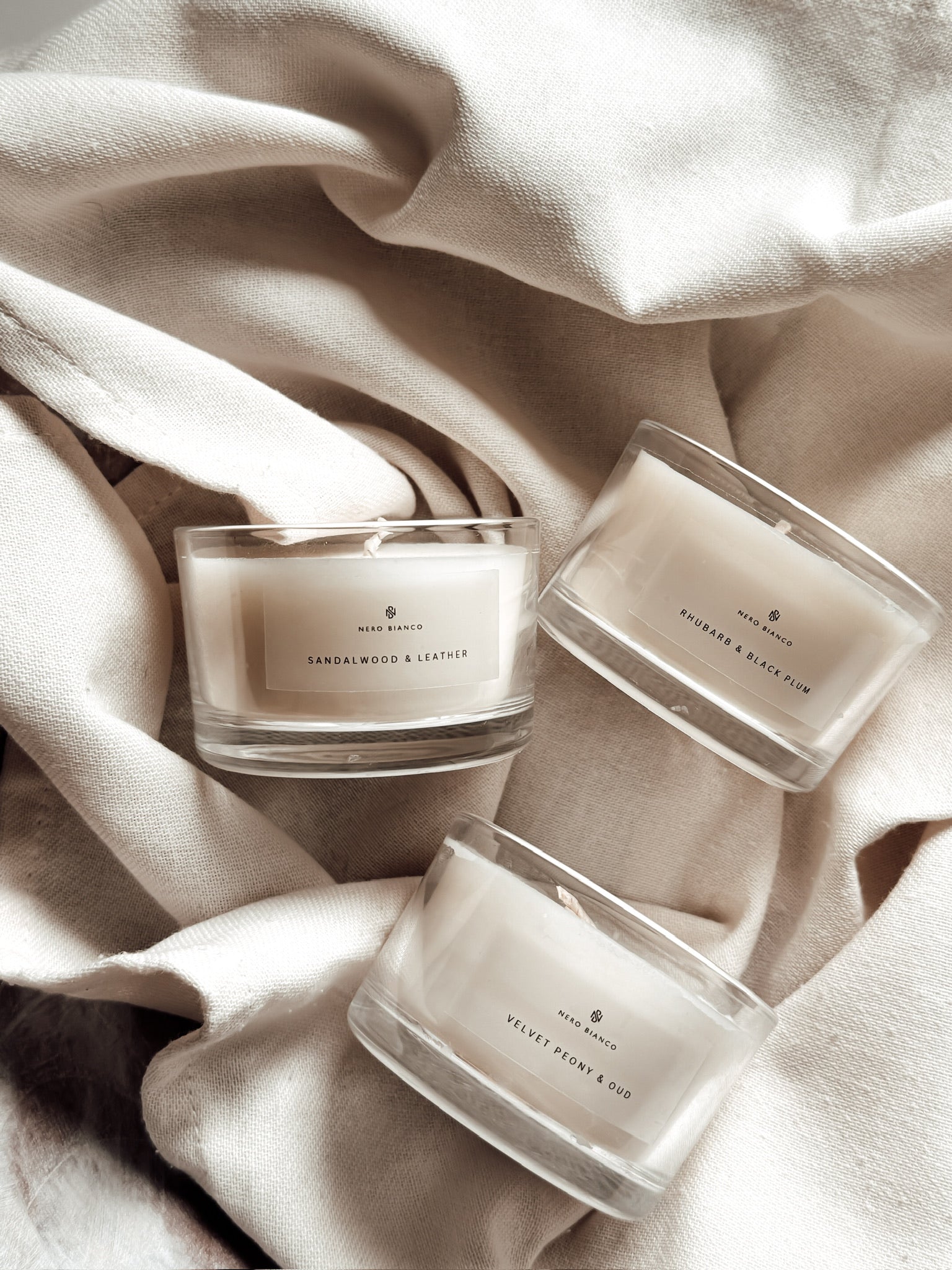 Votive Candles trio in glass vessels on linen cloth
