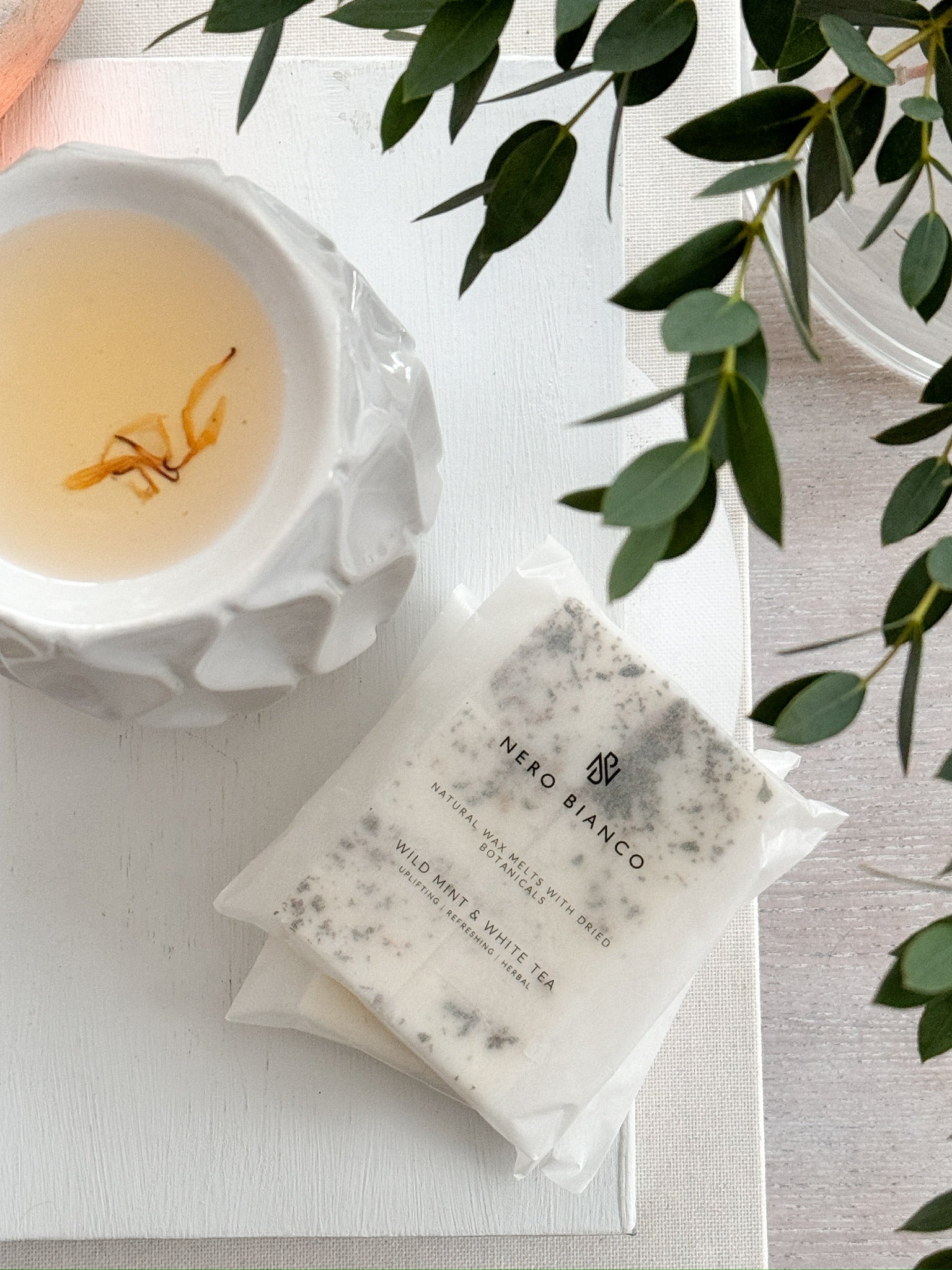 A pack of Nero Bianco wax melts placed on a white surface, with the brand's label visible on the packaging.
