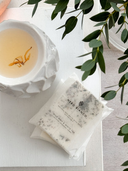 A pack of Nero Bianco wax melts placed on a white surface, with the brand's label visible on the packaging.