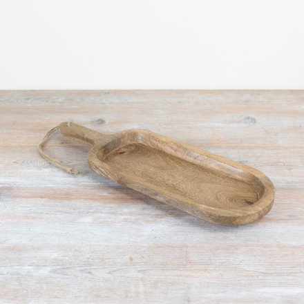 Wooden serving tapas board with handle on a light wooden surface